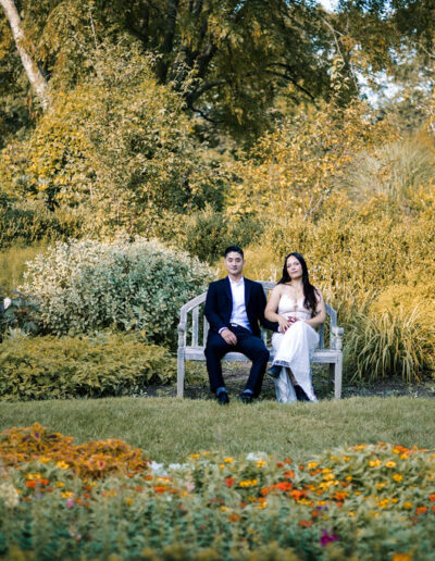 bride and groom on bench in garden